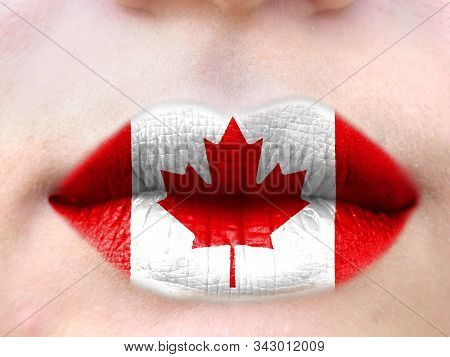 Female Lips Close Up With A Picture Flag Of Canada. Learning Languages.