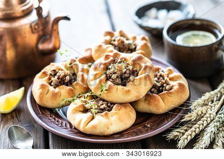 Group Of Individual Pies With Meat And Potato - Vak Balish. Tatar Traditional Pies. Wooden Backgroun