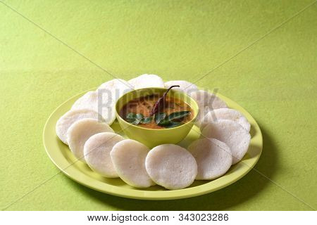 Idli With Sambar In Bowl On Green Background, Indian Dish : South Indian Favourite Food Rava Idli Or