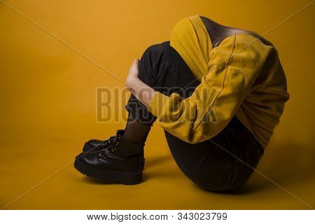 Girl In A Yellow Sweater On A Delt Background