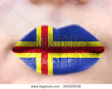 Female Lips Close Up With A Picture Flag Of Aland. Learning Languages.