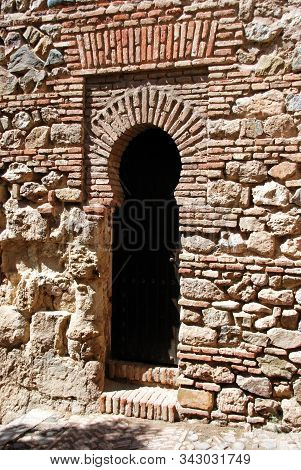 Malaga, Spain - July 7, 2008 - Narrow Arched Doorway Off The Suppliers Courtyard At Malaga Castle, M