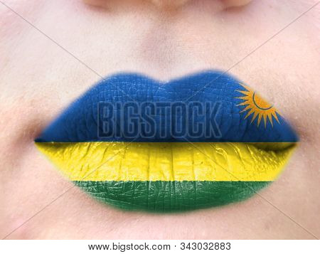 Female Lips Close Up With A Picture Flag Of Rwanda. Learning Languages.
