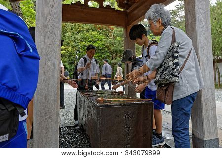 Kamakura, Japan, May 13, 2019 : Traditional Ablution At The Entrance Of Kotoku-in. The Temple Is Ren