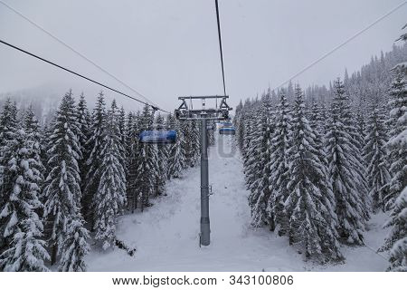 Cableway Station, Elevated Passenger Ropeway At Winter Ski Resort. Modern Chair Lift On Top Of A Mou