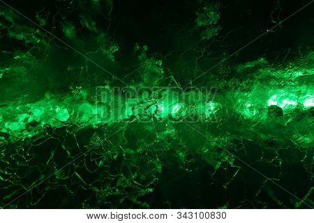 Abstract Dark Green Background - A Series Of Lights Shine Through Cracked Ice