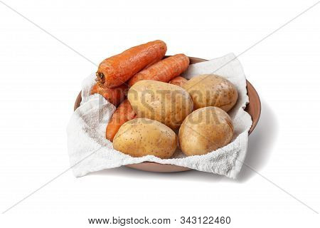 Boiled Potatoes And Carrots On A Towel In A Plate On A White Background