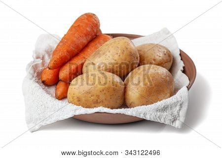 Boiled Potatoes And Carrots On A Towel In A Plate On A White Background