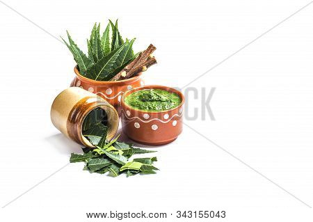 Medicinal Neem Leaves With Paste And Twigs On White Background