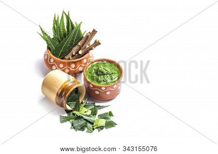 Medicinal Neem Leaves With Paste And Twigs On White Background