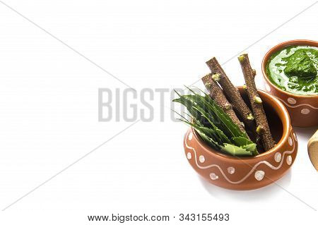 Medicinal Neem Leaves With Paste And Twigs On White Background