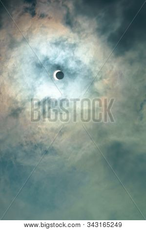 Dramatic Sky With Solar Eclipse. A Shadow Half Closed The Sun.