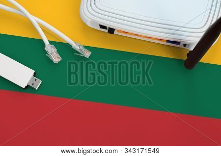 Lithuania Flag Depicted On Table With Internet Rj45 Cable, Wireless Usb Wifi Adapter And Router. Int