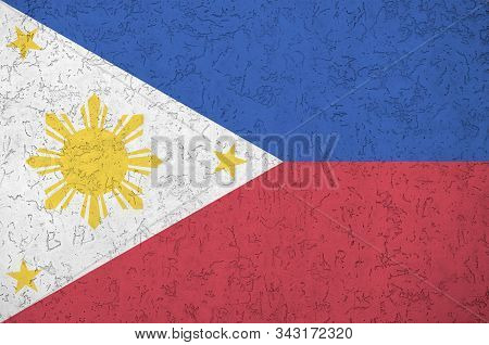 Philippines Flag Depicted In Bright Paint Colors On Old Relief Plastering Wall. Textured Banner On R