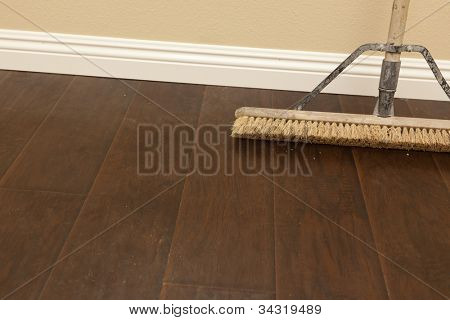 Push-Broom auf einen neu installierten Laminatboden und neuen Sockelleisten.