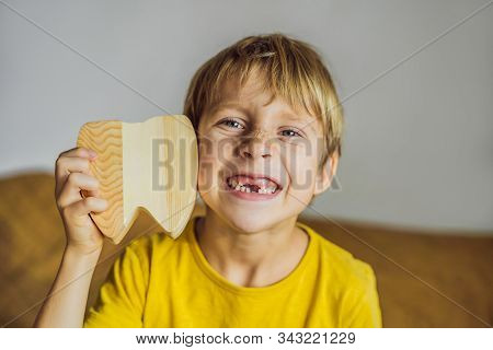 A Boy, 6 Years Old, Holds A Box For Milk Teeth. Change Of Teeth