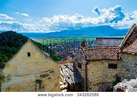 Landscape Photo Taken From The Rasnov Citadel Showing The Rasnov City And The Mountains In The Dista