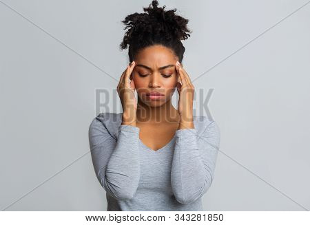 Young Upset Afro Girl Having Headache, Massaging Her Temples, Migraine Concept, Copy Space