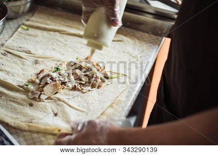 Cooking Fajitos In The Cafe. Cooking Shawarma In Pita In The Kitchen. Wrap Chicken, Carrots, Tomato 