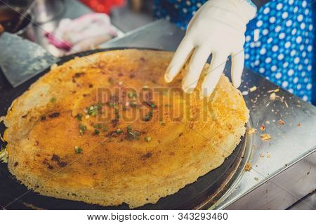 Woman Making Savoury Egg Pancakes In A Small Local Street Outlet Bakery In Yichang Town, China