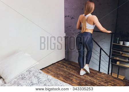 Attrctive Fitness Woman Doing Stretching Exercises At Home, As Part Of A Healthy Lifestyle Without G