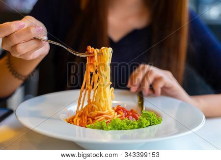 Spaghetti On A Fork. Girl Use Fork With Spaghetti. Pasta With Red Sauce.