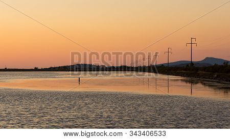 Coast, Sequential Silhouette Power Poles And Sunsets.
