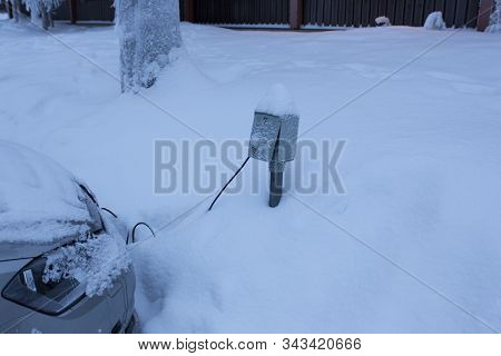 Saariselka, Finland - December 30, 2017: Charging A Plug In Hybrid Vehicle In The Snow Of Lapland