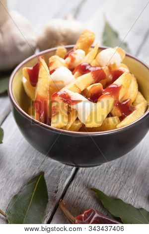 Canadian poutine, fried potato chips with cheese and gravy or sauce