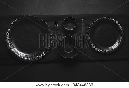 Black Tableware, Plates, Bowls And Cutlery, Empty Dishes, On Black Table. Flat Lay Of Empty Dishes. 