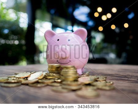 Pink Piggy Bank With 
Gold Coins Pile, Saving Money For Future Investment Plan And Retirement Fund C