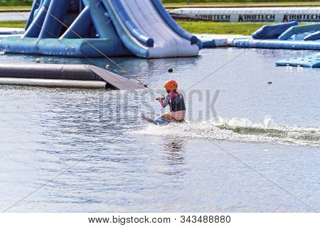 Mackay, Queensland, Australia - January 2020: A Child Wearing A Safety Helmet And Life Jacket Enjoyi