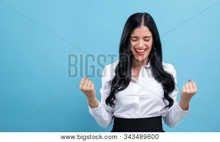 Happy Young Woman Making A Yay Gesture On A Blue Background