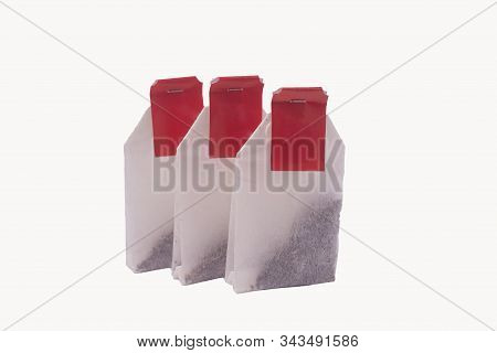 Closeup Of Tea Bags With Red Label Isolated On White Background