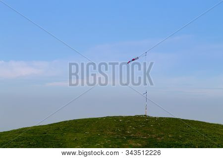Isolated Windsock On Blue Sky, Sport Background. Borso Del Grappa Paragliding Site, Italy