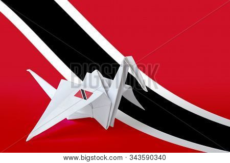 Trinidad And Tobago Flag Depicted On Paper Origami Crane Wing. Handmade Arts Concept