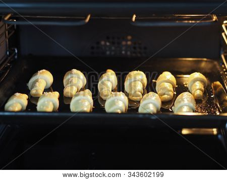 Raw Homemade Bagels On A Black Pan, Ready For Baking In The Oven. Home Kitchen.