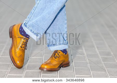 Close-up Of Male Legs In Leather Brown Oxford Semi Brogues Shoes. Photographed In Free Foot Positon 