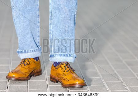 Close-up Of Male Legs In Leather Brown Oxford Semi Brogues Shoes. Photographed In Motion While Walki
