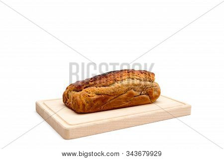 A Homemade Plumcake Standing On A Wooden Board With A White Background