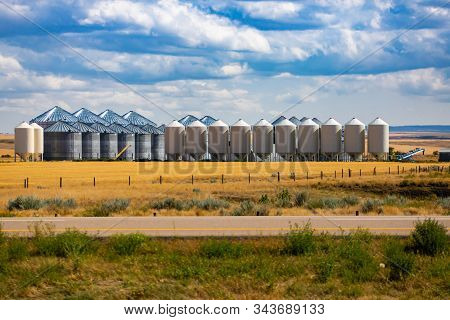 A Wide View Of An Industrial Grain Elevator Complex, With Hopper Bottom Storage Bins And Steel Silos