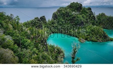 Pianemo Islands, Blue Lagoon With Green Rocks, Raja Ampat, West Papua. Indonesia