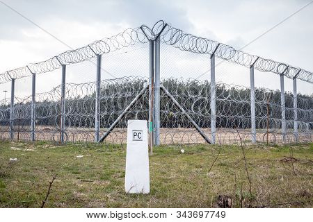 Border Fence Between Subotica (serbia) & Kelebia (hungary) With A Boundary Marker. This Border Wall 