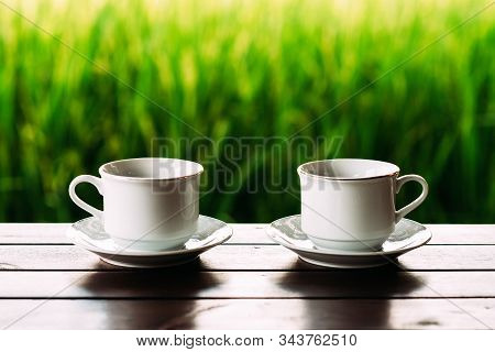 White Tea Cups On A Beautiful Background. White Coffee Cups Against The Background Of Rice Terraces 