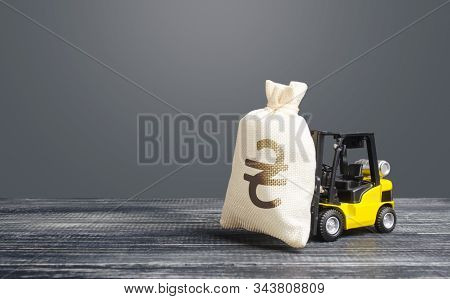 Yellow Forklift Carries A Ukrainian Hryvnia Uah Money Bag. Big Contract, Profitable Deposit, Take A 