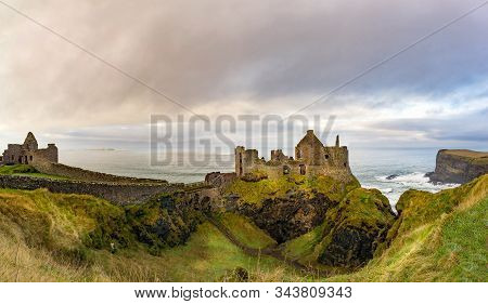 Ruined Medieval Dunluce Castle On The Cliff In Bushmills Town. Filming Location Of Popular Tv Show. 
