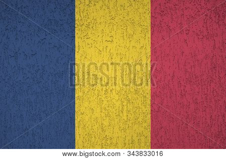 Chad Flag Depicted In Bright Paint Colors On Old Relief Plastering Wall. Textured Banner On Rough Ba