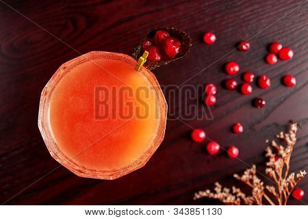 Red Cocktail In Coupe Glass With Cranberry Juice Decorated With Fresh Cranberries In Nori Cone, Cosm