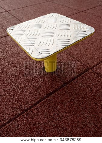 Outdoor Exercising On Step Platform On Red Rubbery Flexible Background.  Safety Tile Floor Made By P