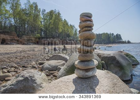 Stones Balance On The Beach. Place On Latvian Coasts Called Veczemju Klintis